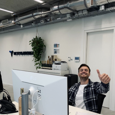 Colleague behind laptop with thumbs up